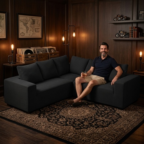 Best Man Cave Furniture: 10 Essential Pieces for the Ultimate Hangout: Sectional Sofa Man sitting on black sectional sofa